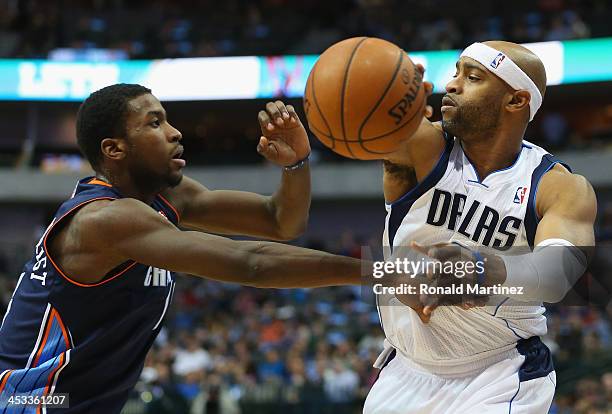Vince Carter of the Dallas Mavericks passes the ball against Michael Kidd-Gilchrist of the Charlotte Bobcats at American Airlines Center on December...
