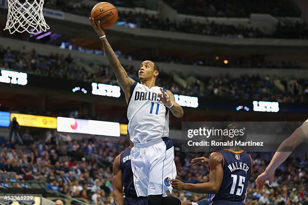 Monta Ellis of the Dallas Mavericks takes a shot against Kemba Walker of the Charlotte Bobcats at American Airlines Center on December 3, 2013 in...