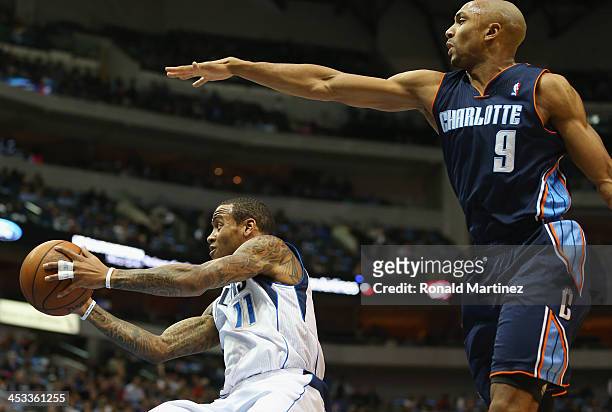Monta Ellis of the Dallas Mavericks passes the ball against Gerald Henderson of the Charlotte Bobcats at American Airlines Center on December 3, 2013...