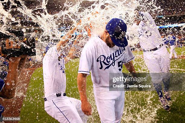 Closer Greg Holland of the Kansas City Royals is doused with water by Danny Duffy and Salvador Perez after recording his 100th career save as the...