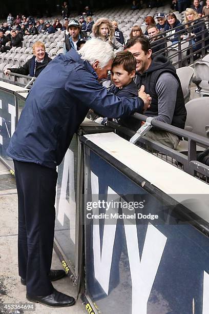 Blues coach Michael Malthouse greets his grandson before the round 20 AFL match between the Carlton Blues and the GOld Coast Titans at Etihad Stadium...