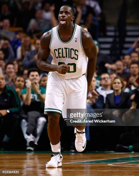 Brandon Bass of the Boston Celtics reacts following a basket in the fourth quarter against the Milwaukee Bucks during the game at TD Garden on...