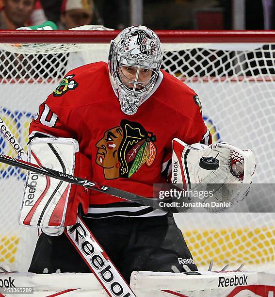 Corey Crawford of the Chicago Blackhawks makes a glove save in the second period against the Dallas Stars at the United Center on December 3, 2013 in...