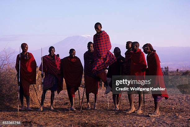 Kenya, Amboseli, Masai Men, High Jump, Mt. Kilimanjaro In Background.