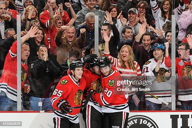 Nick Leddy of the Chicago Blackhawks celebrates with teammates Andrew Shaw and Brandon Saad after scoring against the Dallas Stars in the second...