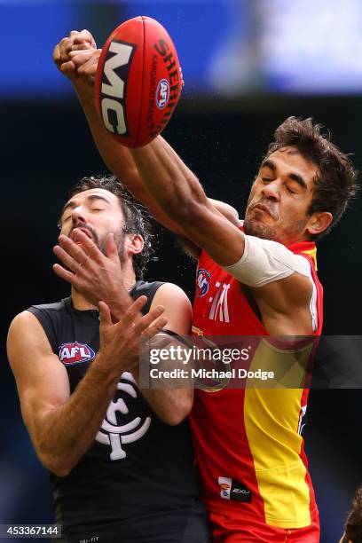Kade Simpson of the Blues competes for the ball against Jack Martin of the Suns during the round 20 AFL match between the Carlton Blues and the GOld...