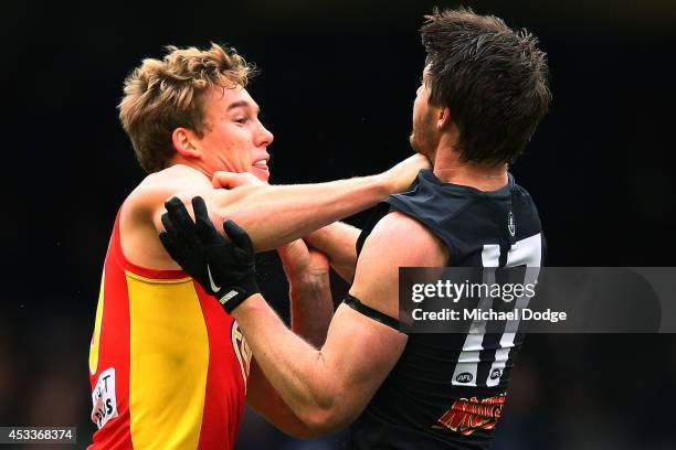 Tom Lynch of the Suns wrestles with Sam Rowe of the Blues during the round 20 AFL match between the Carlton Blues and the GOld Coast Titans at Etihad...