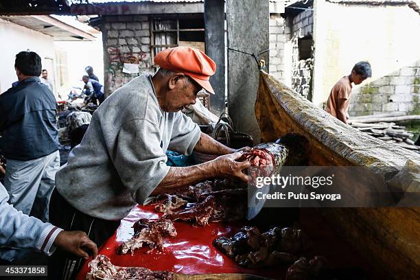 Man measures the weight of the snake meat at Langowan traditional market on August 9, 2014 in Langowan, North Sulawesi. The Langowan traditional...