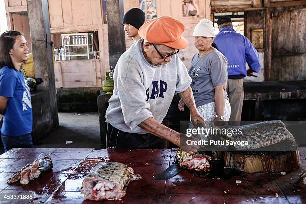 Man cuts snake at Langowan traditional market on August 9, 2014 in Langowan, North Sulawesi. The Langowan traditional market is famous for selling a...