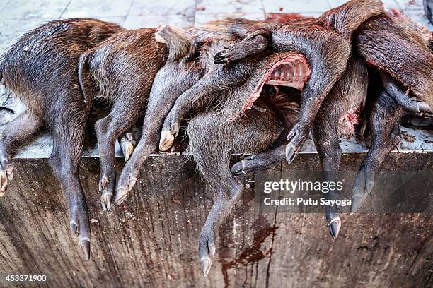 Wild boar thighs for sale at Langowan traditional market on August 9, 2014 in Langowan, North Sulawesi. The Langowan traditional market is famous for...