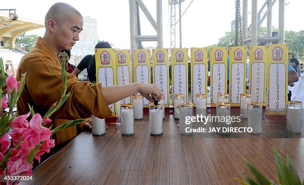 Chinese Buddhist monk performs rites for a day of special prayers at the Quirino Grandstand in Manila on August 9 in memory of the victims of a...