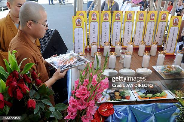 Chinese Buddhist monks perform rites for a day of special prayers at the Quirino Grandstand in Manila on August 9 in memory of the victims of a...