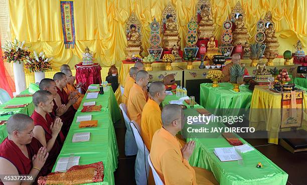Chinese Buddhist monks perform rites for a day of special prayers at the Quirino Grandstand in Manila on August 9 in memory of the victims of a...