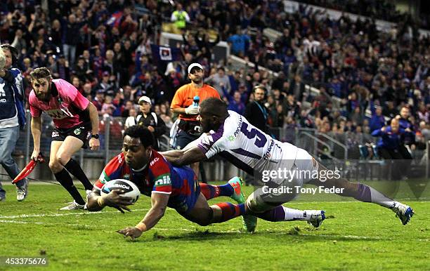 Akuila Uate of the Knights scores a try with seconds to go during the round 22 NRL match between the Newcastle Knights and the Melbourne Storm at...