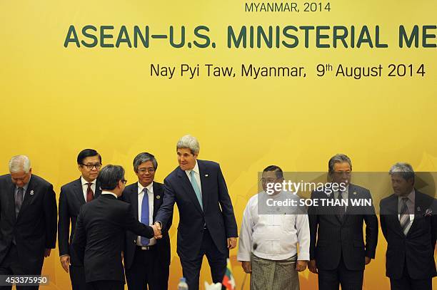Secretary of State John Kerry shakes hands with Indonesia's Foreign Minister Marty Natalegawa prior a photo session for the US-ASEAN Ministerial...
