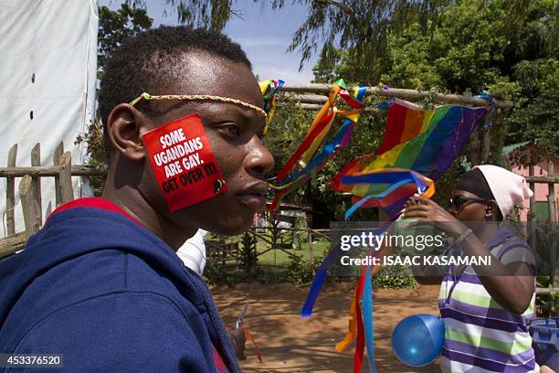 Ugandan man with a sticker on his face takes part on August 9, 2014 in the annual gay pride in Entebbe, Uganda. Uganda's attorney general has filed...