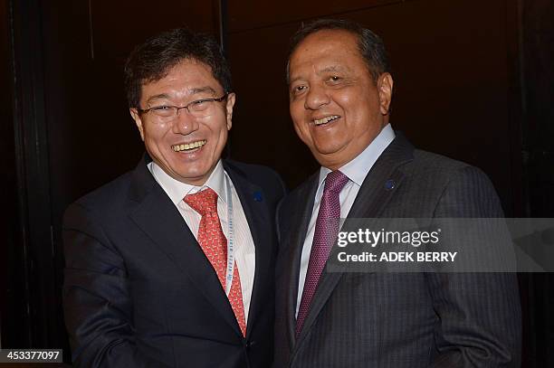 South Korean Trade Minister Yoon Sang-Jick and Indonesia's Industry Minister M.S. Hidayat pose for a photograph after holding a bilateral meeting on...