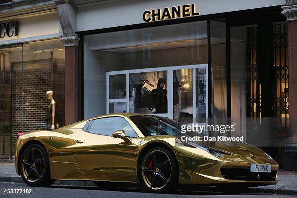Gold Ferrari sits outside Chanel on Sloane Street on August 8, 2014 in London, England. Tourists and car enthusiasts have been flocking to the...