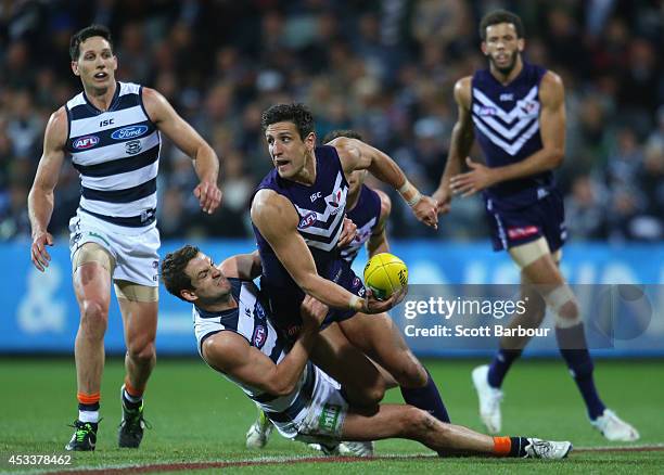 Matthew Pavlich of the Dockers is tackled during the round 20 AFL match between the Geelong Cats and the Fremantle Dockers at Skilled Stadium on...