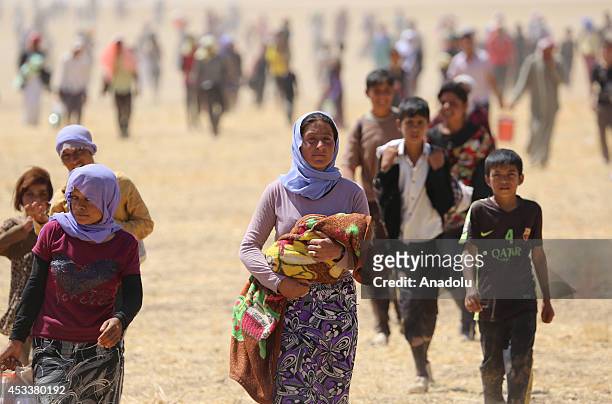 Thousands of Yezidis trapped in the Sinjar mountains as they tried to escape from Islamic State forces, are rescued by Kurdish peshmerga forces and...