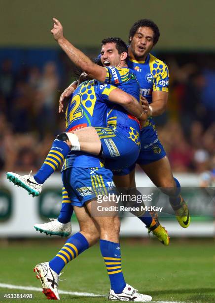 Tepai Moeroa of the Eels celebrates his try with team mates Isaac de Gois and Bureta Faraimo during the round 22 NRL match between the Parramatta...