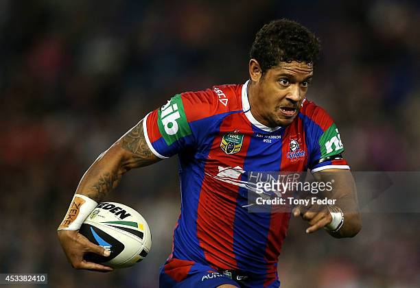 Dane Gagai of the Knights runs with the ball during the round 22 NRL match between the Newcastle Knights and the Melbourne Storm at Hunter Stadium on...