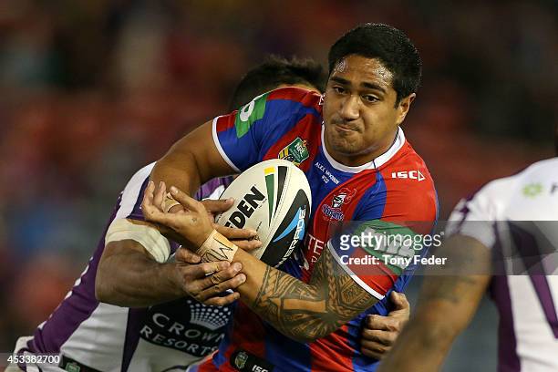 Chanel Mata'Utia of the Knights is tackled by the Storm defence during the round 22 NRL match between the Newcastle Knights and the Melbourne Storm...