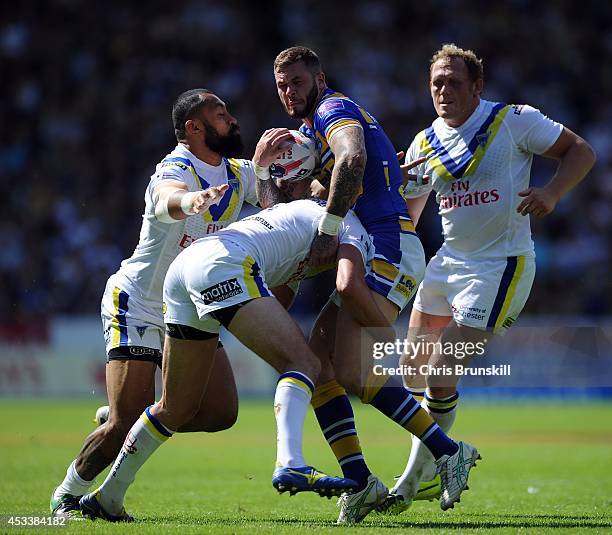 Zak Hardaker of Leeds Rhinos is tackled by Stefan Ratchford and Roy Asotasi of Warrington Wolves during the Tetley's Challenge Cup Semi Final match...