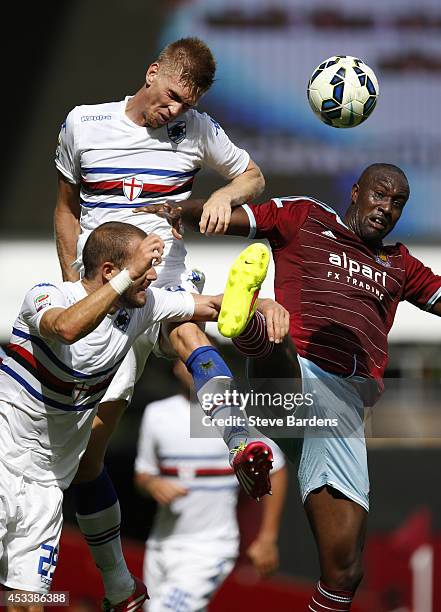 Bartosz Salamon of Samdoria wins a header from Carlton Cole of West Ham United during the pre-season friendly match between West Ham United and...