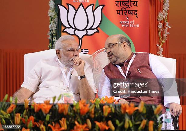 Prime Minister Narendra Modi talking with Bharatiya Janata Party National President Amit Shah during the BJP National Council meeting at Jawaharlal...
