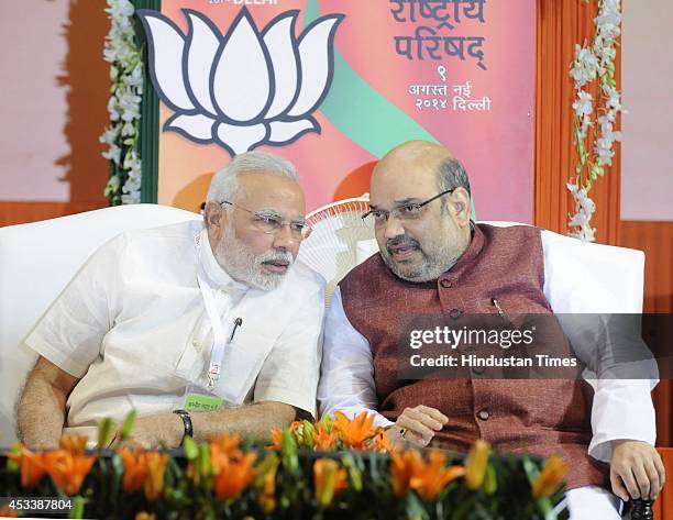 Prime Minister Narendra Modi talking with Bharatiya Janata Party National President Amit Shah during the BJP National Council meeting at Jawaharlal...