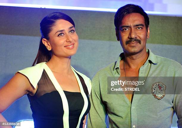 Indian Bollywood actors Kareena Kapoor Khan and Ajay Devgn pose for a photograph during a promotional event for the forthcoming Hindi film 'Singham...