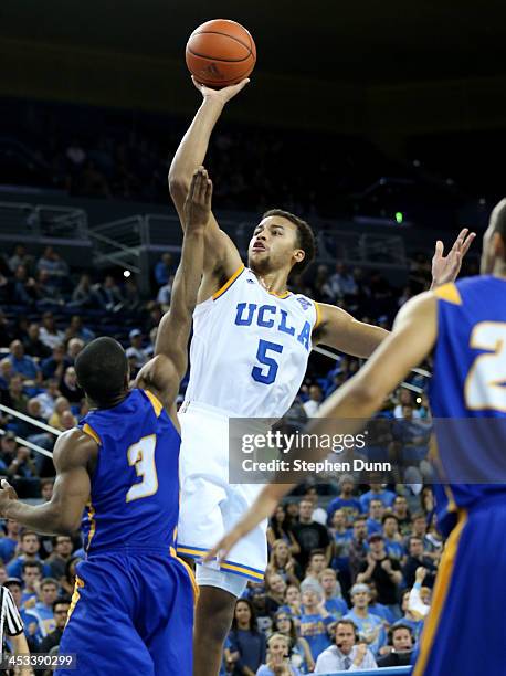 Kyle Anderson of the UCLA Bruins shoots over Zalmico Harmon of the UCSB Gauchos at Pauley Pavilion on December 3, 2013 in Los Angeles, California....