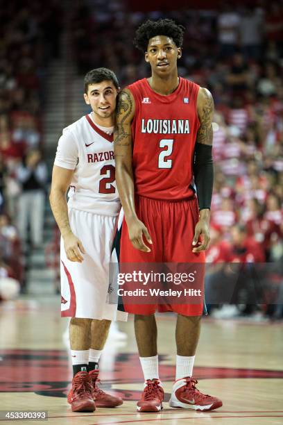 Elfrid Payton of the Louisiana Ragin' Cajuns is guarded by Kikko Haydar of the Arkansas Razorbacks at Bud Walton Arena on November 15, 2013 in...