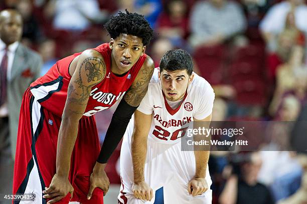 Elfrid Payton of the Louisiana Ragin' Cajuns is guarded by Kikko Haydar of the Arkansas Razorbacks at Bud Walton Arena on November 15, 2013 in...