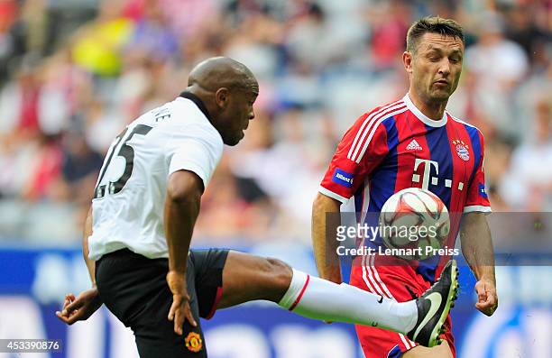 Robert Kovac of FCB AllStars challenges Quinton Fortune of ManUtd Legends during the friendly match between FC Bayern Muenchen AllStars and...