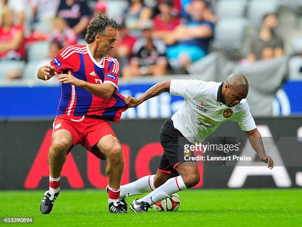 Maurizio Gaudino of FCB AllStars challenges Quinton Fortune of ManUtd Legends during the friendly match between FC Bayern Muenchen AllStars and...