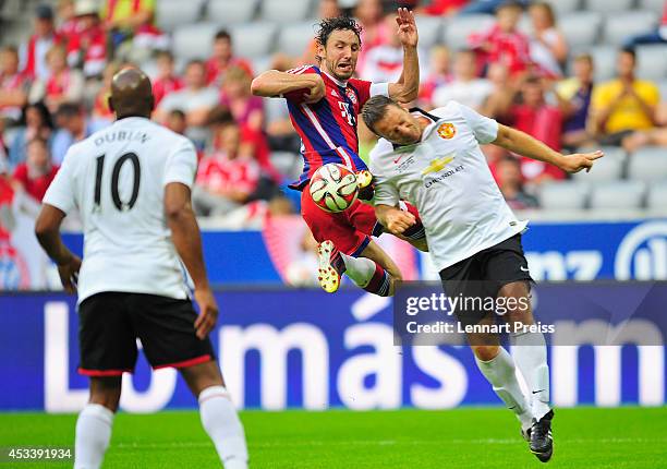 Mark van Bommel of FCB AllStars challenges Denis Irwin of ManUtd Legends during the friendly match between FC Bayern Muenchen AllStars and Manchester...