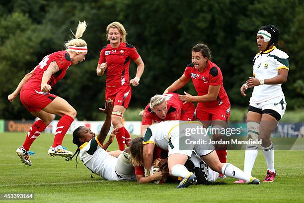 Wales players celebrate after Sioned Harries of Wales scored a try during the IRB Women's Rugby World Cup Pool C match between Wales and South Africa...