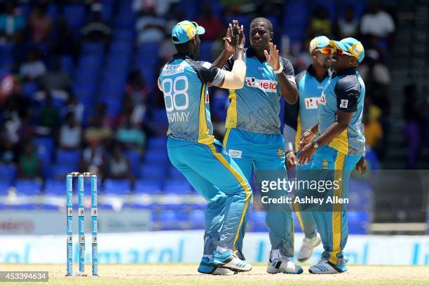 Darren Sammy , Mervin Matthew and Liam Sebastien of St. Lucia Zouks celebrate a wicket during a match between Jamaica Tallawahs and St. Lucia Zouks...