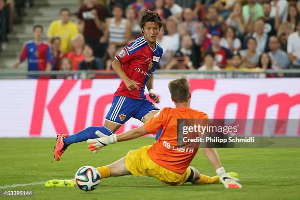 Yoichiro Kakitani of FC Basel scores a goal against goalkeeper David Da Costa of FC Zurich during the Raiffeisen Super League match between FC Basel...