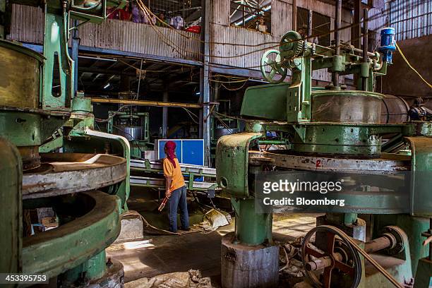 Worker monitors a conveyor as tea leaves pass through leaf maceration machines at the Highfield Tea Estate factory in Coonoor, Tamil Nadu, India, on...