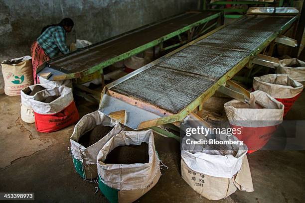 Tea is distributed into bags as it passes though a grading machine at the Santosh Tea Industries Pvt. Factory in Coonoor, Tamil Nadu, India, on...