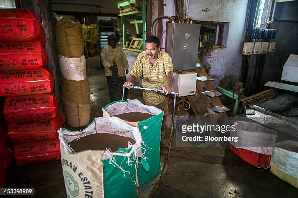 Worker pushes a trolley laden with bags of tea through the Santosh Tea Industries Pvt. Factory in Coonoor, Tamil Nadu, India, on Saturday, Nov. 30,...