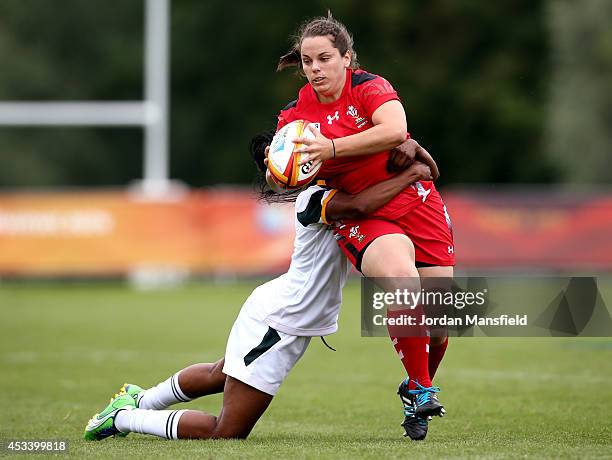 Lowri Harries of Wales is tackled by Sinazo Nobele of South Africa during the IRB Women's Rugby World Cup Pool C match between Wales and South Africa...