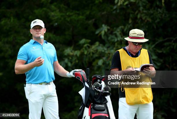 Jamie Donaldson of Wales waits with his caddie Mick Donaghy on the 18th hole during the third round of the 96th PGA Championship at Valhalla Golf...