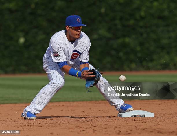 Javy Baez of the Chicago Cubs makes a fielding error against the Tampa Bay Rays at Wrigley Field on August 9, 2014 in Chicago, Illinois.