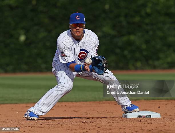 Javy Baez of the Chicago Cubs makes a fielding error against the Tampa Bay Rays at Wrigley Field on August 9, 2014 in Chicago, Illinois.