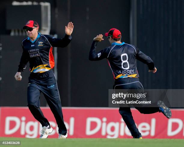 Ben Dunk of Antigua Hawksbills celebrates taking a catch to dismiss Darren Bravo of The Trinidad and Tobago Red Steel during a match between Antigua...