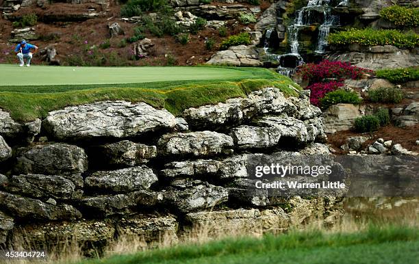 Rory McIlroy of Northern Ireland lines up his putt on the 13th green during the third round of the 96th PGA Championship at Valhalla Golf Club on...